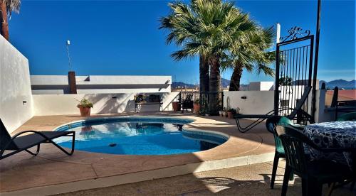 圣卡洛斯Casa Loma Bella 1 con Alberca Privada Vista Increible的庭院内的游泳池,配有桌椅