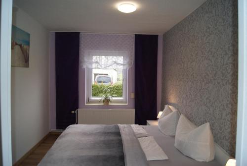 NeubukowHas und Igel的一间卧室设有一张大床和一个窗户。
