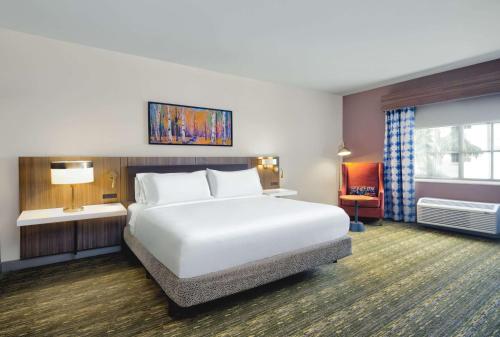 圣露西港圣露西港/美国职业高尔夫球协会村希尔顿花园酒店的酒店客房设有白色的床和窗户。