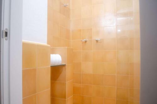 巴兰基亚Faranda Collection Barranquilla, a member of Radisson Individuals的带淋浴的浴室(铺有橙色瓷砖)