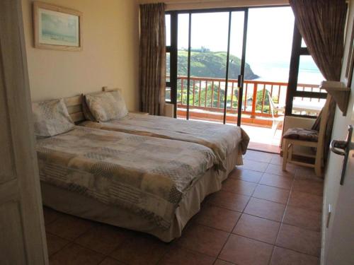 咖啡湾Sea View的一间卧室设有一张床和一个阳台