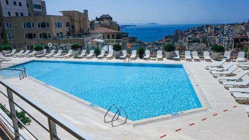 伊斯坦布尔塔克西姆马尔马拉酒店的一个带躺椅的游泳池,享有城市美景