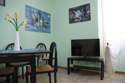 斯波莱托La Fontana的一间带桌子和电视的用餐室