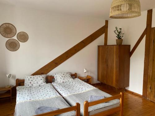 茨兹伊特纳Agroturystyka Bobrowniki的一间卧室设有两张单人床和一个楼梯。