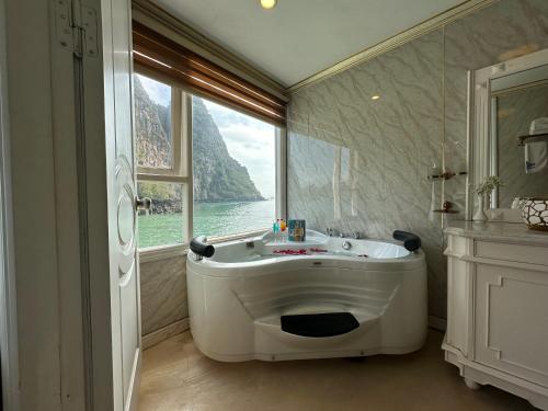 下龙湾Halong AQUAR CRUISE的带浴缸的浴室和大窗户