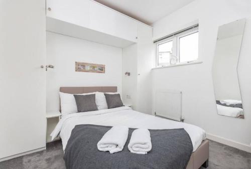 KentTheodora Suite 3 - Free Parking的一间卧室配有一张带两条白色毛巾的床