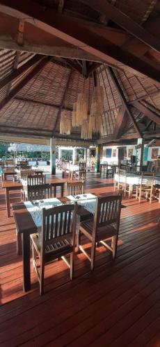 贝岛Le Moya Beach的木制甲板上配有桌椅的用餐区
