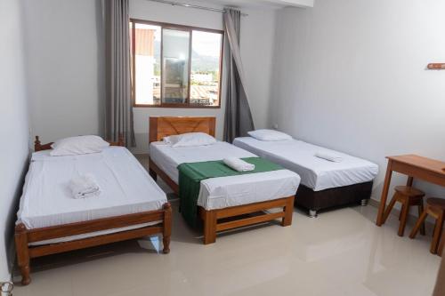 塔拉波托Humazapa的客房设有两张床和窗户。