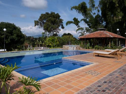 蒙特内哥罗Finca Hotel Santana的一个带庭院和凉亭的游泳池