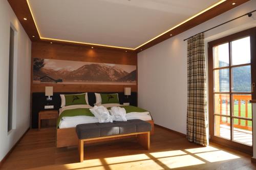 阿亨基希Hotel-Garni "Das Seebichl"的一间卧室设有一张床和一个大窗户