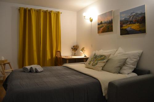 库尔布瓦Studio 88的一间卧室配有床和黄色窗帘