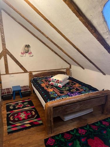 舒加塔格盐矿镇Casa Colț din Maramureș - Old Traditional House的小房间,配有床和地毯