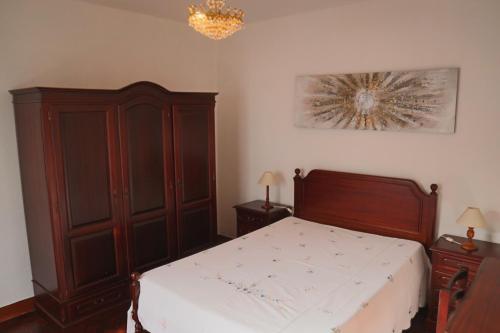 里韦拉布拉瓦Fifty's House 2的一间卧室配有一张床和一个木制橱柜