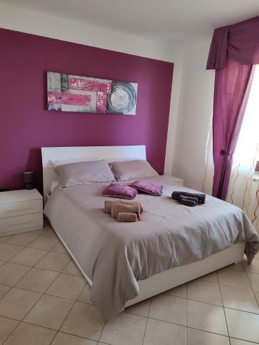 萨萨里Dario's house的一间卧室设有一张紫色墙壁的大床