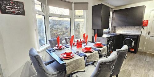 伦敦Stratford City - Luxe house with garden的餐桌、椅子和带洗衣机的厨房