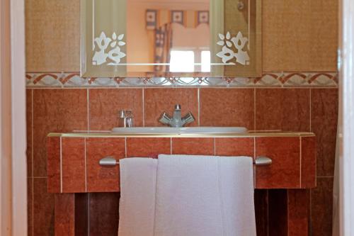 丹吉尔大陆酒店的浴室配有盥洗盆、镜子和毛巾