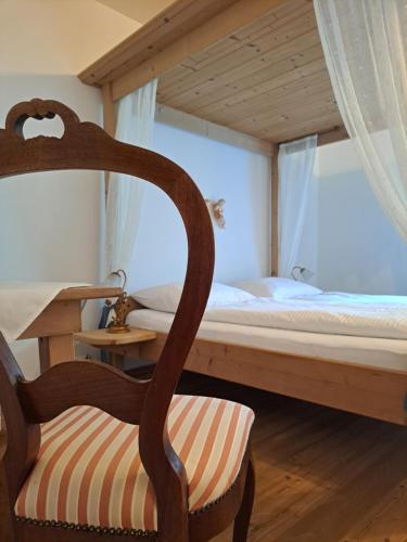 因斯布鲁克Stauders Zimmer und Ferienwohnungen的一间卧室配有双层床和椅子