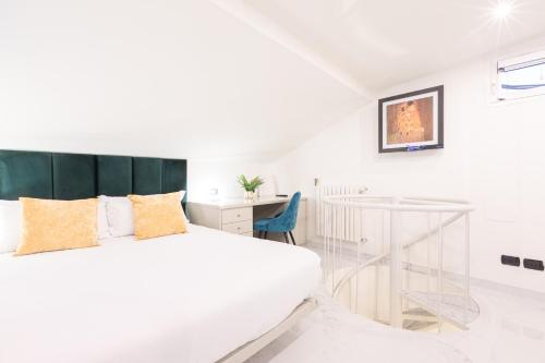 米兰Monte Napoleone Split-level Terrace Apartment - Top Collection的白色卧室配有床和书桌