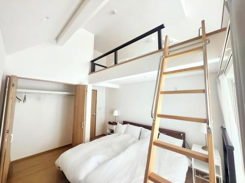 二世古Niseko White Villas1的一间卧室配有一张双层床和梯子