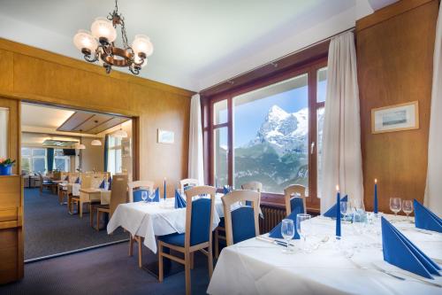 米伦阿尔卑山酒店的山景餐厅,配有桌椅