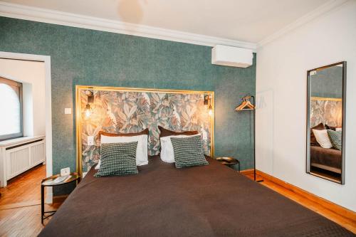 梅赫伦Porta Superia Boutique B&B的一间卧室配有一张带绿色和白色枕头的大床