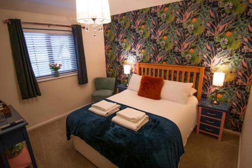 CottinghamThe Royal George的一间卧室配有带毛巾的床