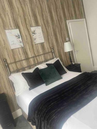 哈特尔普尔Cosy modern one bedroom flat的一间卧室配有一张带黑白枕头的床