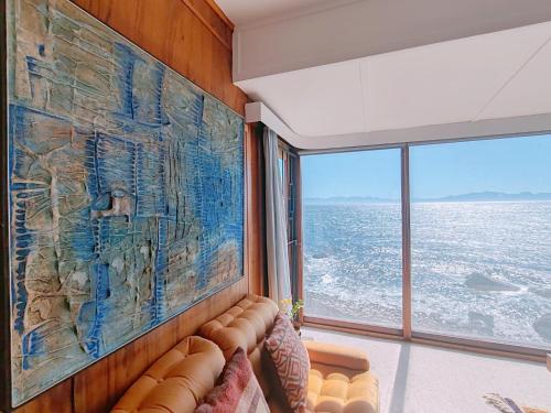 西蒙镇Timber's Ocean House的客厅配有沙发和墙上的大画