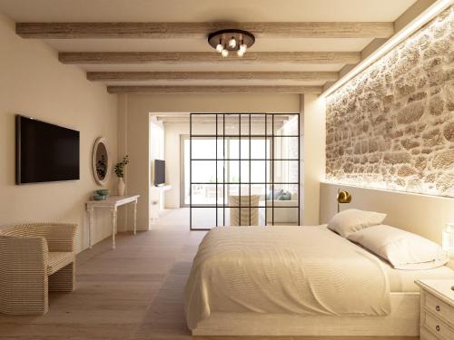 赫索尼索斯罗福思公寓酒店的卧室配有一张白色的大床和石墙