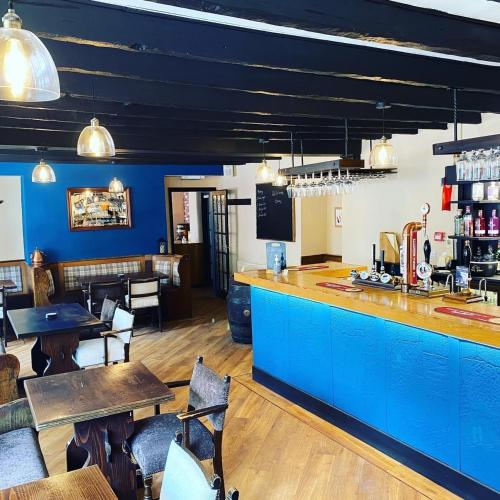 LongframlingtonThe Granby Inn的餐厅设有蓝色柜台和桌椅