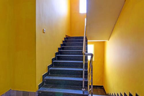 BārangOYO Shibani & Suhani的黄色墙壁的房间里,楼梯
