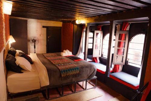 帕坦希拉宾馆的一间设有床铺的卧室,位于带窗户的房间内
