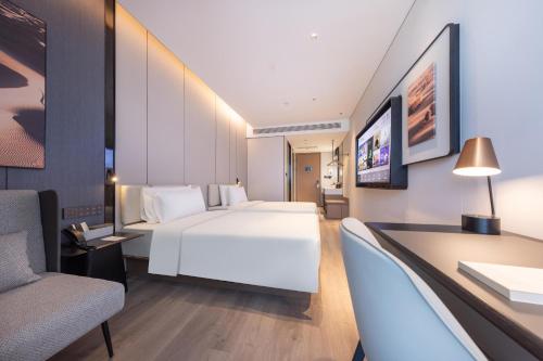 北京北京北清路永丰科技园亚朵酒店的一间酒店客房,配有一张白色的床和一张书桌