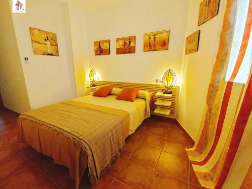 加鲁查El Mirador de Garrucha的卧室配有一张床,墙上配有两盏灯。