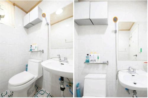 高阳市Ria House的白色的浴室设有卫生间和水槽。
