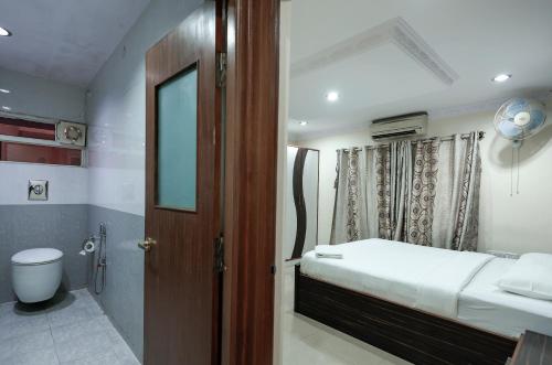 班加罗尔Falcon Suites Koramangala的一间带床的小卧室和一间浴室
