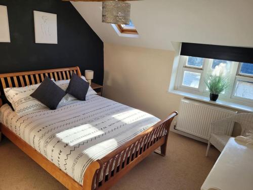 LlwyngwrilCosy modern cottage by the sea, heart of snowdonia的一间卧室配有一张大床和枕头