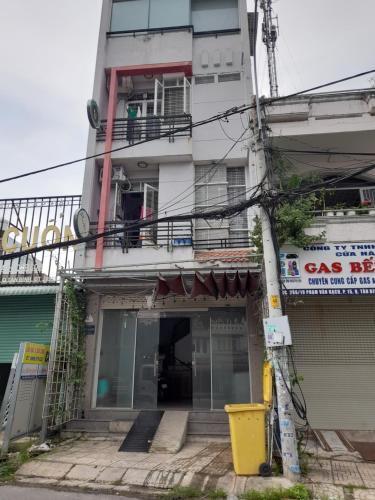 胡志明市Homestay Linh的一座高大的白色建筑,上面设有阳台