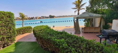 杜拉特阿拉尔درة العروس شاليه شاطئ البرادايس的一个带凉亭和水的游泳池