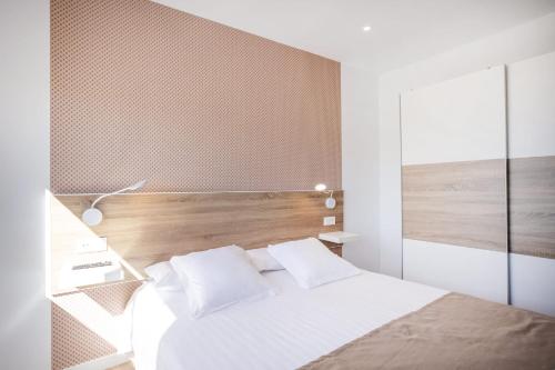 绍萨尔Casa Senderos del Norte的卧室配有白色的床和木制床头板