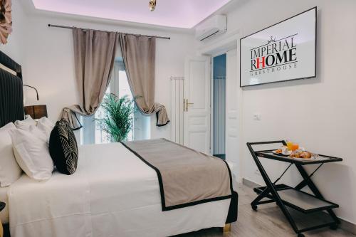 罗马Imperial Rhome Guest House的卧室配有一张白色的大床和一张桌子