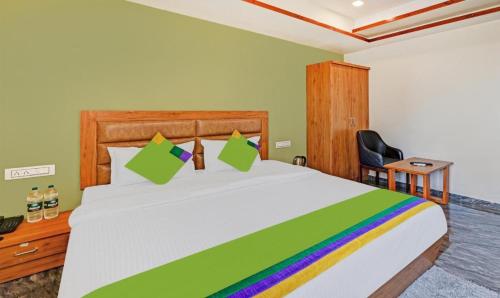 艾哈迈达巴德Hotel Shree Regency, Ahmedabad的卧室配有一张带彩虹床罩的白色大床