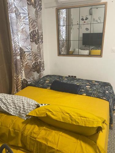 卡宴La sagesse的一间卧室配有黄色的床和镜子