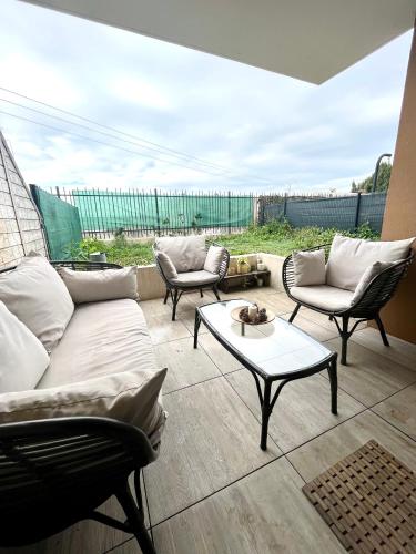 维特罗勒Superbe appart avec Jardin à 2 min de l’Aéroport-4 pers的客厅配有沙发、椅子和桌子