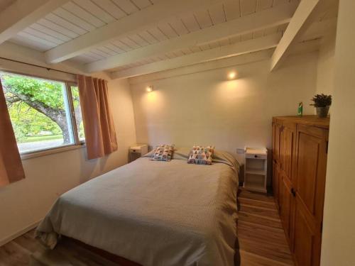普埃洛湖Linaje Hotel Boutique & Relax的一间卧室配有带两个枕头的床和窗户
