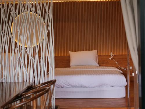 Ban Rak ThaiHedreung banrakthai homestay and camping的卧室配有一张床铺,位于带墙壁的房间