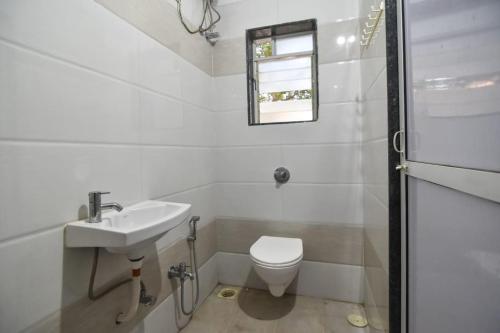 罗纳瓦拉ll 2BHK ll PRIVATE POOL ll GOOD LUCK VILLA ll FREE BREAKFAST的白色的浴室设有水槽和卫生间。