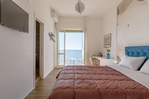 萨莱诺Cas’ A Mare - Beachfront Luxury Suites的一间卧室设有一张大床和一个大窗户
