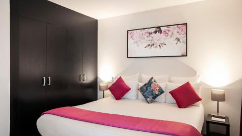 蒙泰夫兰雷斯迪家瓦勒欧洲酒店的卧室配有带红色枕头的大型白色床