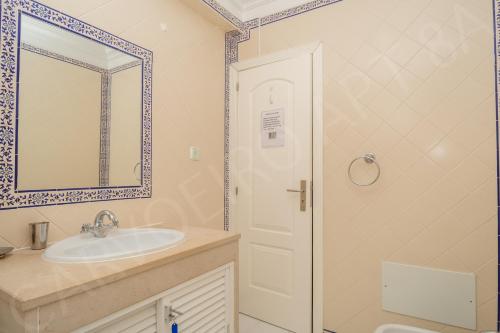 卡武埃鲁Carvoeiro 8A的一间带水槽、镜子和淋浴的浴室
